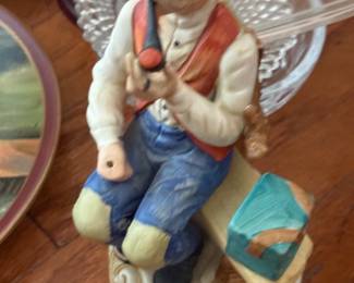 Porcelain figurine of farmer man playing harmonica in overalls