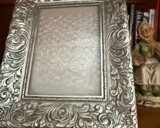 Ornate silver-tone repousse picture frame with scroll design