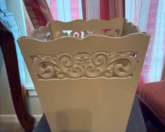 Cream painted wood wastebasket with carved scroll cutout design