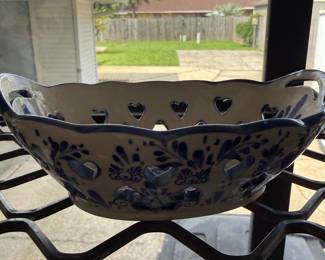 Blue and white ceramic bowl with pierced heart cutouts