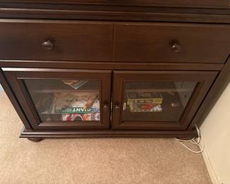 Wood cabinet with glass doors and bun feet
