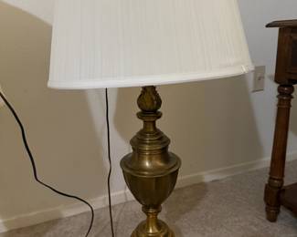 Brass urn-shaped table lamp with pleated white shade