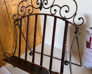 Scrolled wrought iron wall shelf with hanging ball chains