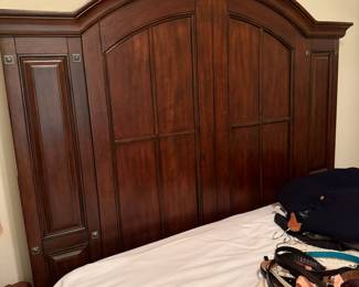 Arched wood queen headboard with paneled side towers and pulls