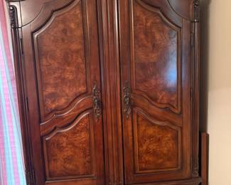 Carved wood burl armoire with scrolled crown and brass pulls