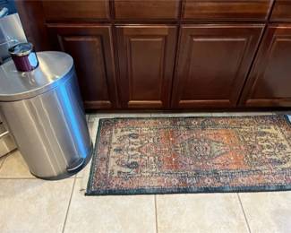 Odyssey Area Rug And Metal Trash Can.