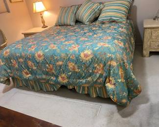 King Bed Frame, Mattress Set, And Colorful Bedding.