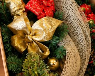 Assorted Christmas wreaths & holiday greenery with decorative bows