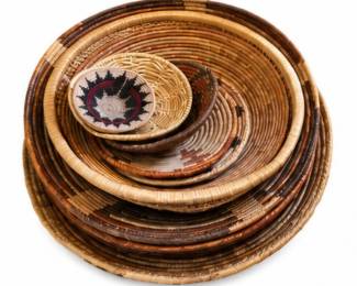 Nested collection of handcrafted woven baskets in natural brown and tan tones.