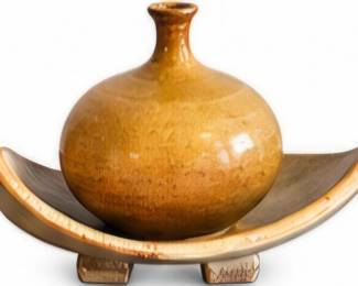 Pottery vase on curved stand