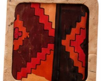 Southwestern-style framed geometric artwork in warm earth tones.