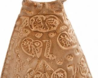 Decorative carved bell with loop handle.