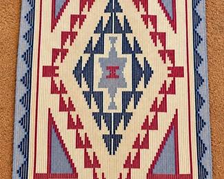 SW-style woven accent rug with a central geometric medallion and stepped motifs in burgundy, navy, blue-gray and cream, finished with a coordinating geometric border.