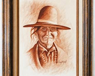Framed sepia portrait of a Native American man in a wide-brimmed hat.