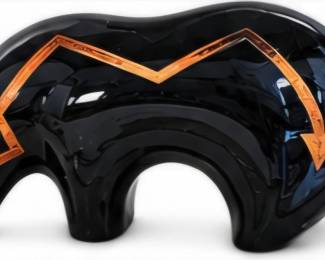 Large glossy black sculptural décor piece accented with geometric copper-colored detailing.,