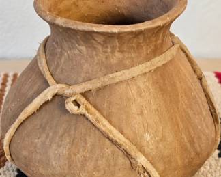 Rustic earthenware pot with wrapped cord detail.