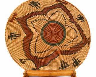 Decorative handwoven basket with bold geometric patterns in earthy tones.