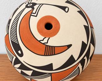 Southwestern pottery vessel with bold black and terracotta geometric design.