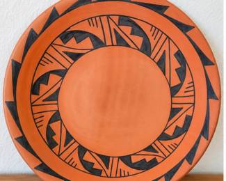 Southwestern terracotta platter with bold black geometric design.