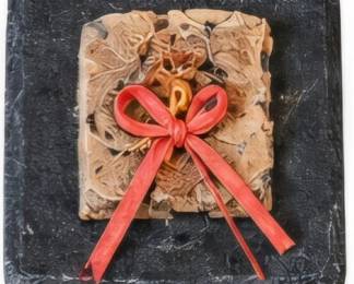 Decorative tile with dimensional red bow design