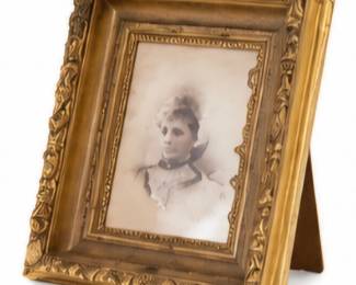 Antique portrait photograph in an ornate gold-tone frame.