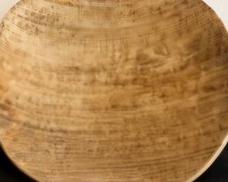 Rustic carved wooden bowl with natural grain and textured detailing.
