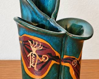 Sculptural teal pottery vase with Southwestern petroglyph-style design.