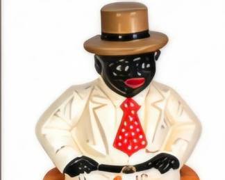 Decorative seated gentleman figurine wearing a white suit, red tie and top hat.