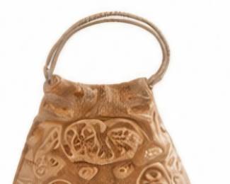 Decorative carved bell with loop handle.