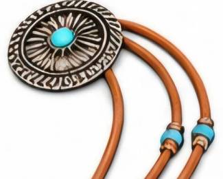 SW-style bolo tie with turquoise-colored center and leather cords.