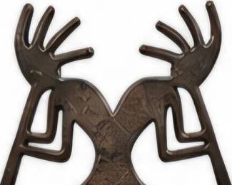 Black metal Southwestern-style double figure sculpture with raised arms.