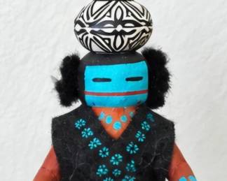 Handcrafted Kachina-style figure with turquoise face, black attire, geometric pottery-style headpiece and colorful painted accents.