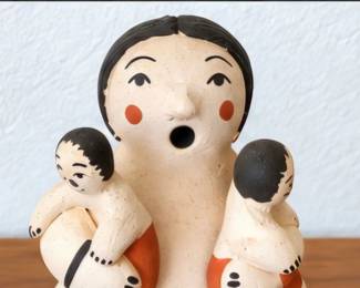 Large Storyteller Figure — Pueblo-style pottery figure with three child figures, raffia accents, and black-and-cream painted details.