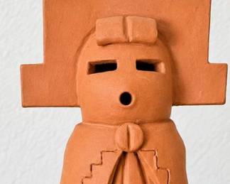 Handcrafted terracotta figure with geometric headdress and detailed feather design.