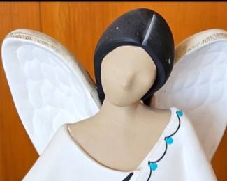 Angel figurine with Southwestern-style turquoise and black accents.