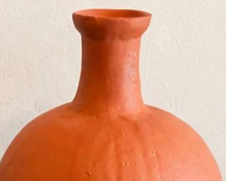Orange terracotta-style round vase with a narrow neck and rustic finish.
