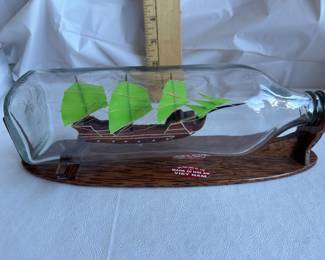 Miniature Glass Ship in a Bottle on Wooden Stand