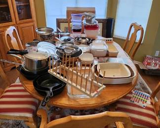 Oak dinning room table, chairs, cook ware and corner oak china cabinet
