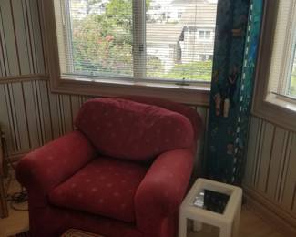 Cozy upholstered arm chair; cocktail table