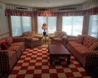 Matching plaid couches; upholstered arm chairs; coffee table; accent table; table lamp