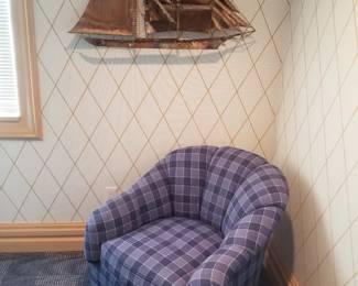 Plaid upholstered arm chair; metal wall art