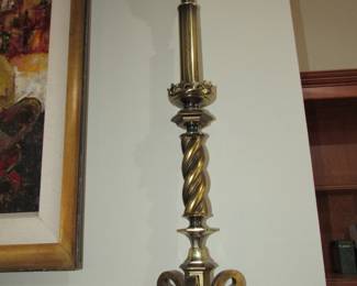 One of two tall brass lamps