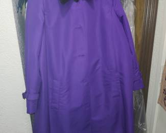Lauren Ralph Lauren women's purple trench coat / car coat featuring a contrasting black velvet collar. It features a single-breasted hidden placket button closure, long sleeves with buckled cuff straps, and front slant pockets. This specific piece is a vintage or archival style