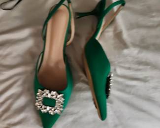 Brio Brooch Pumps: green satin slingback pumps adorned with a striking, square-shaped rhinestone buckle embellishment on the pointed toe box.