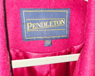 Vintage Pendleton women's wool coat. It features a classic single-breasted, button-front design with a structured shirt collar, clean raglan or set-in shoulders, and side slash pockets. Pendleton is highly regarded for its high-quality 100% virgin wool and wool-blend outerwear crafted in traditional, rich colorways like this vibrant crimson red.