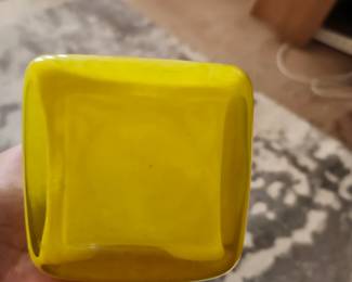 yellow rectangular hand-blown art glass vase. It features a modern, minimalist rectangular profile with a flat face and slightly rounded corners. The glass has a slightly mottled, cloudy, or textured interior appearance common in studio-blown art glass.