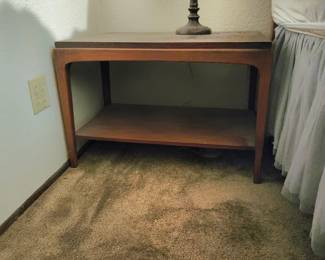 Pair- Mid-Century Modern two-tiered walnut end table from the Rhythm collection by Lane Furniture, specifically Style #997-05. [1] (https://epochfurnishings.com/product/pair-mid-century-modern-walnut-end-tables-lane-rhythm-c-1965/), [2] (https://www.aptdeco.com/product/pair-mid-century-end-tables-by-lane), [3] (https://www.auctionninja.com/sistersincharge/product/lane-rhythm-collection-mid-century-modern-solid-wood-coffee-table-with-shelf-style-997-05-700722.html)Produced in the mid-1960s, this iconic line is defined by its clean architectural lines, a subtly raised or stepped trim along the top edges, and elegant tapered legs that cradle the frame. 
