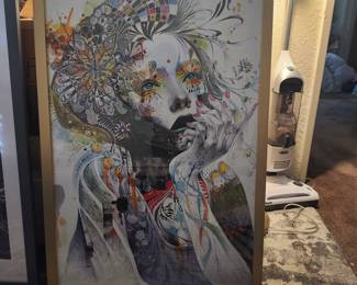 This framed wall art is "Circulation" by Minjae Lee, featuring a vibrant, colorful portrait of a woman adorned with intricate floral and abstract patterns.