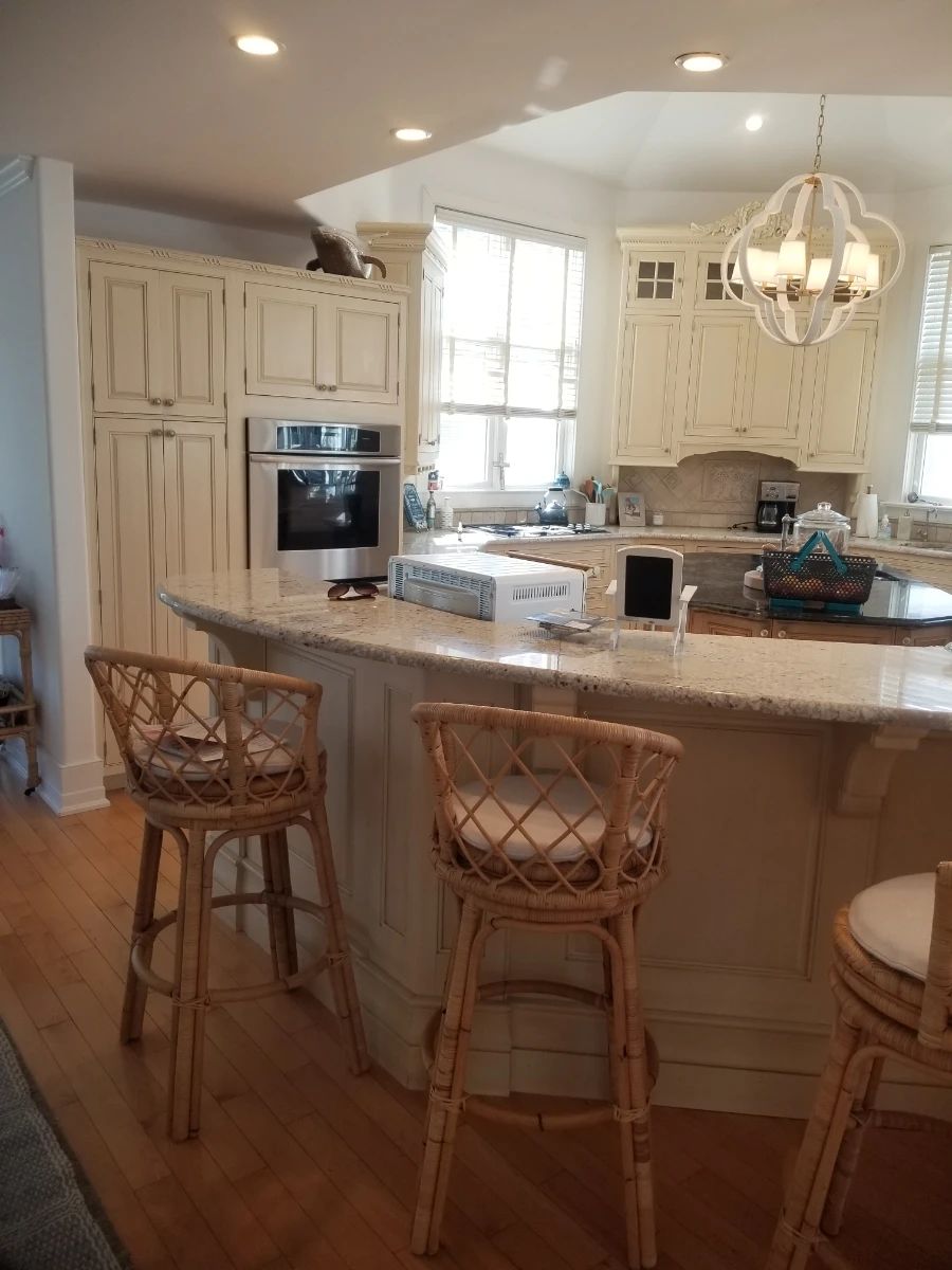 Large Wood-Mode kitchen with an island. Serena & Lily bar stools