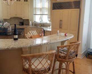Wood-Mode kitchen with an island. Serena & Lily bar stools